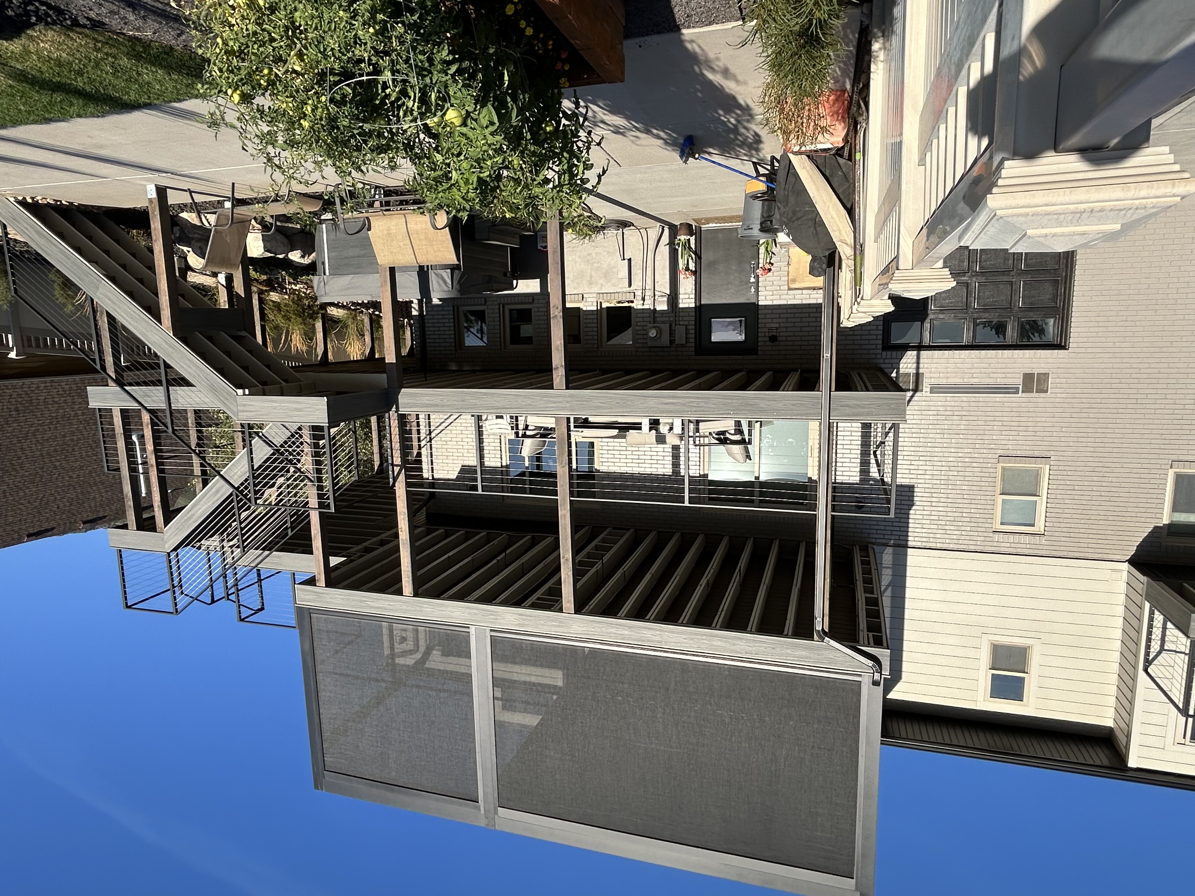 Ground-level composite deck with built-in bench seating. Perfect for backyard movie nights.